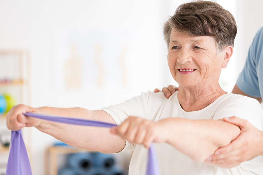 Elderly woman pulling elastic band 