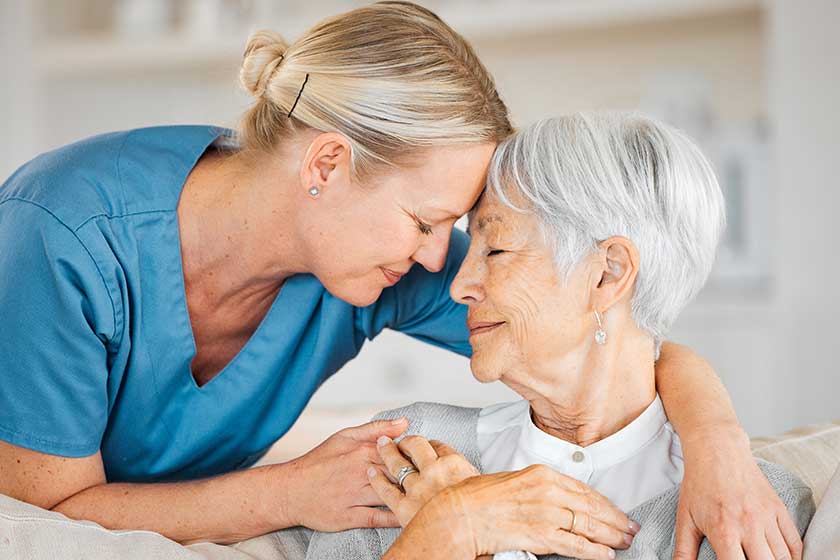 A nurse caring for a senior woman at home.